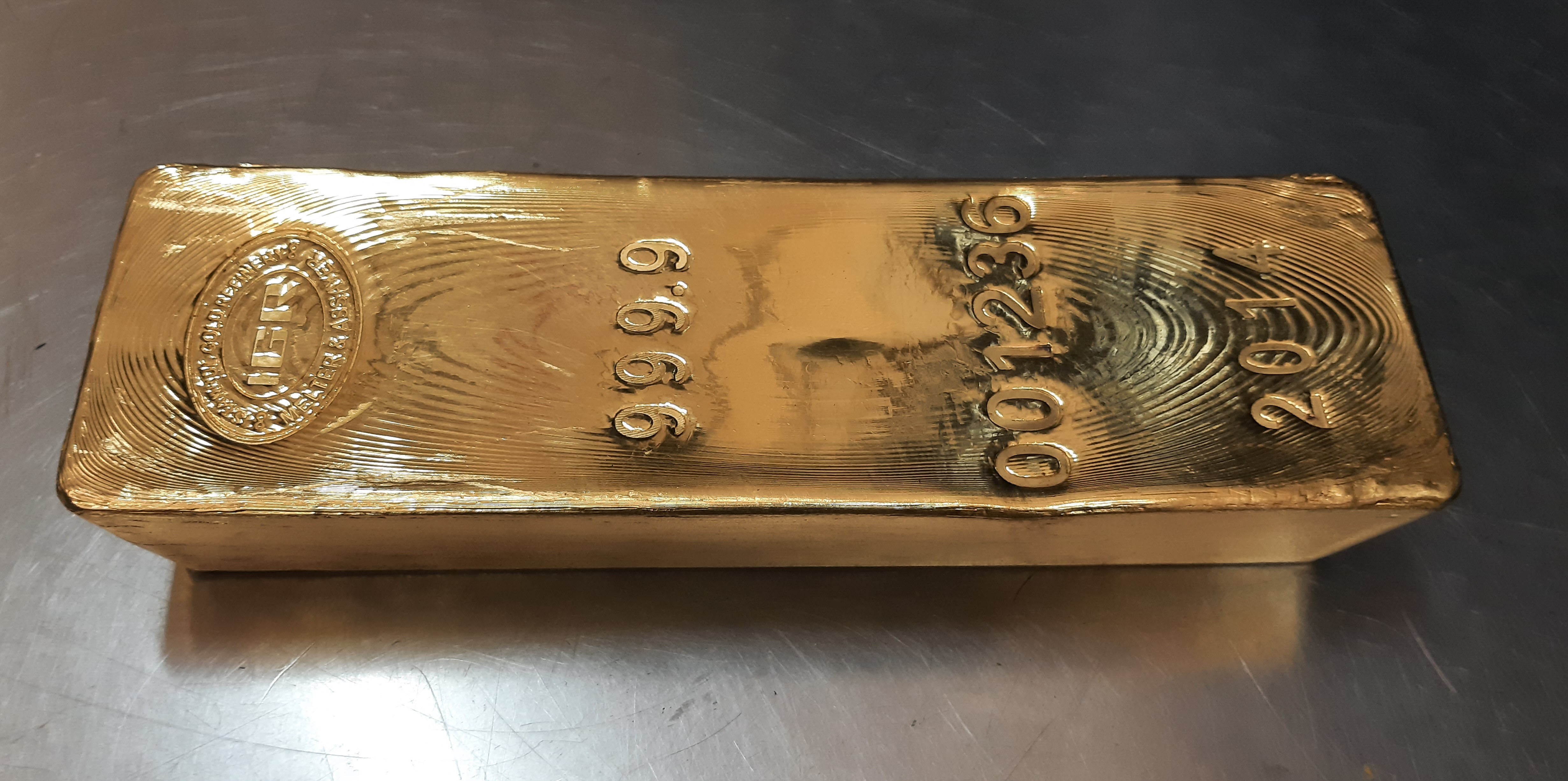 Gold bar 99.99% pure gold wholesale bar in a vault Gold bar 99.99% pure gold wholesale bar in a vault