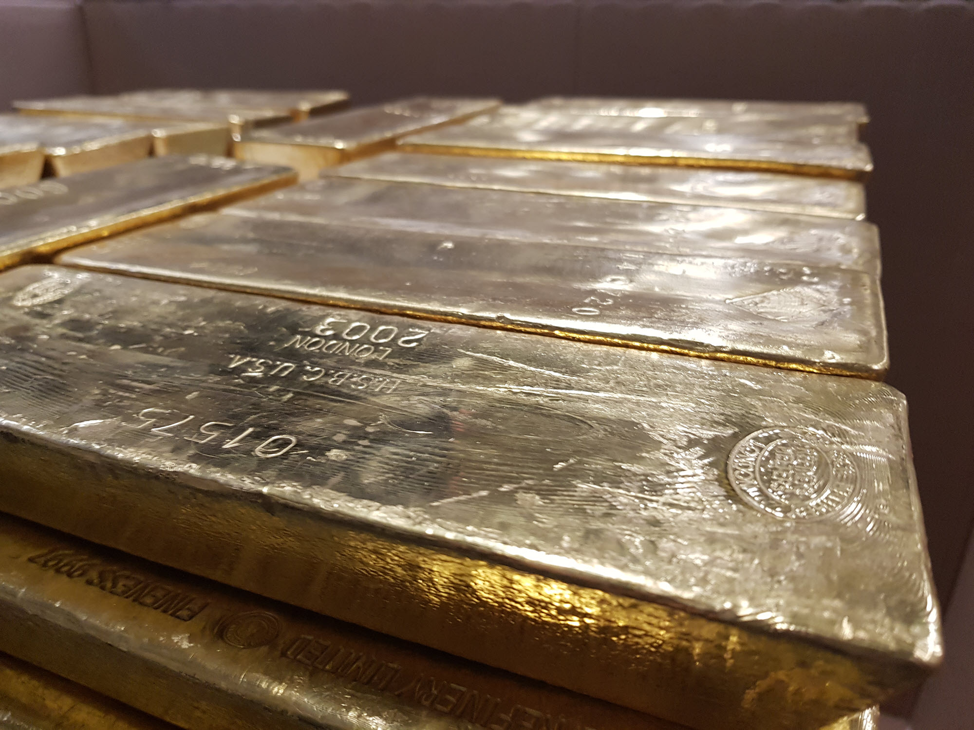 Close-up of gold bars stacked on a pallet Close-up of gold bars stacked on a pallet