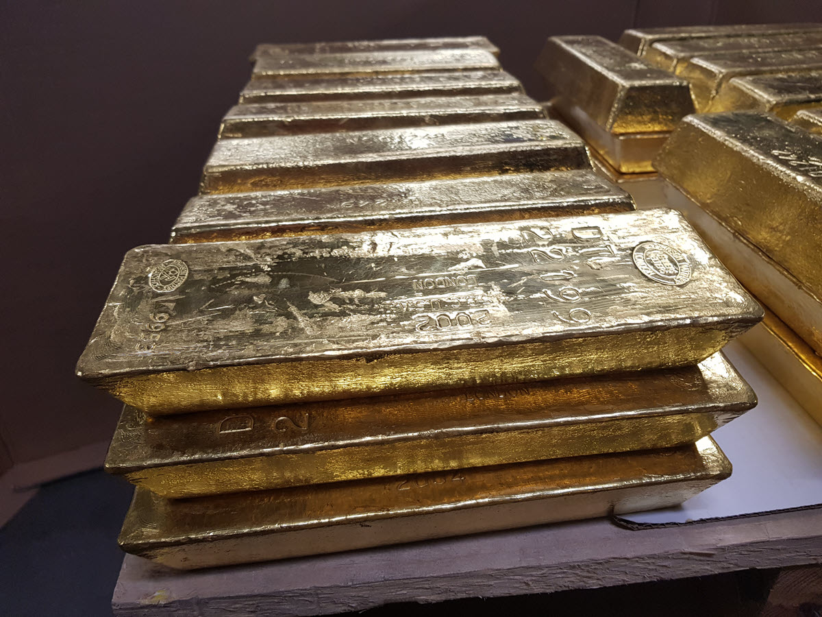 Gold bars stacked 3 high on a pallet in a vault Gold bars stacked 3 high on a pallet in a vault
