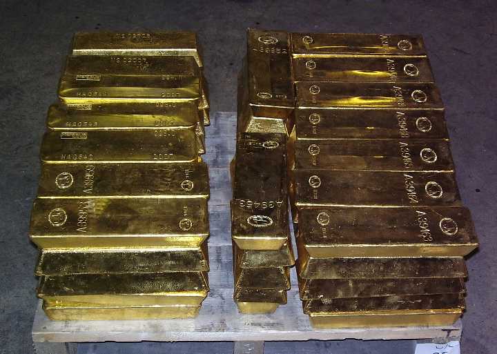 Gold bars stacked on a pallet within a wholesale bullion vault Gold bars stacked on a pallet within a wholesale bullion vault
